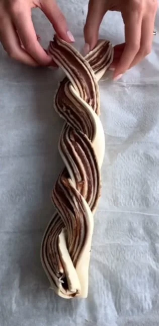 Twisting Nutella puff pastry into a wreath shape